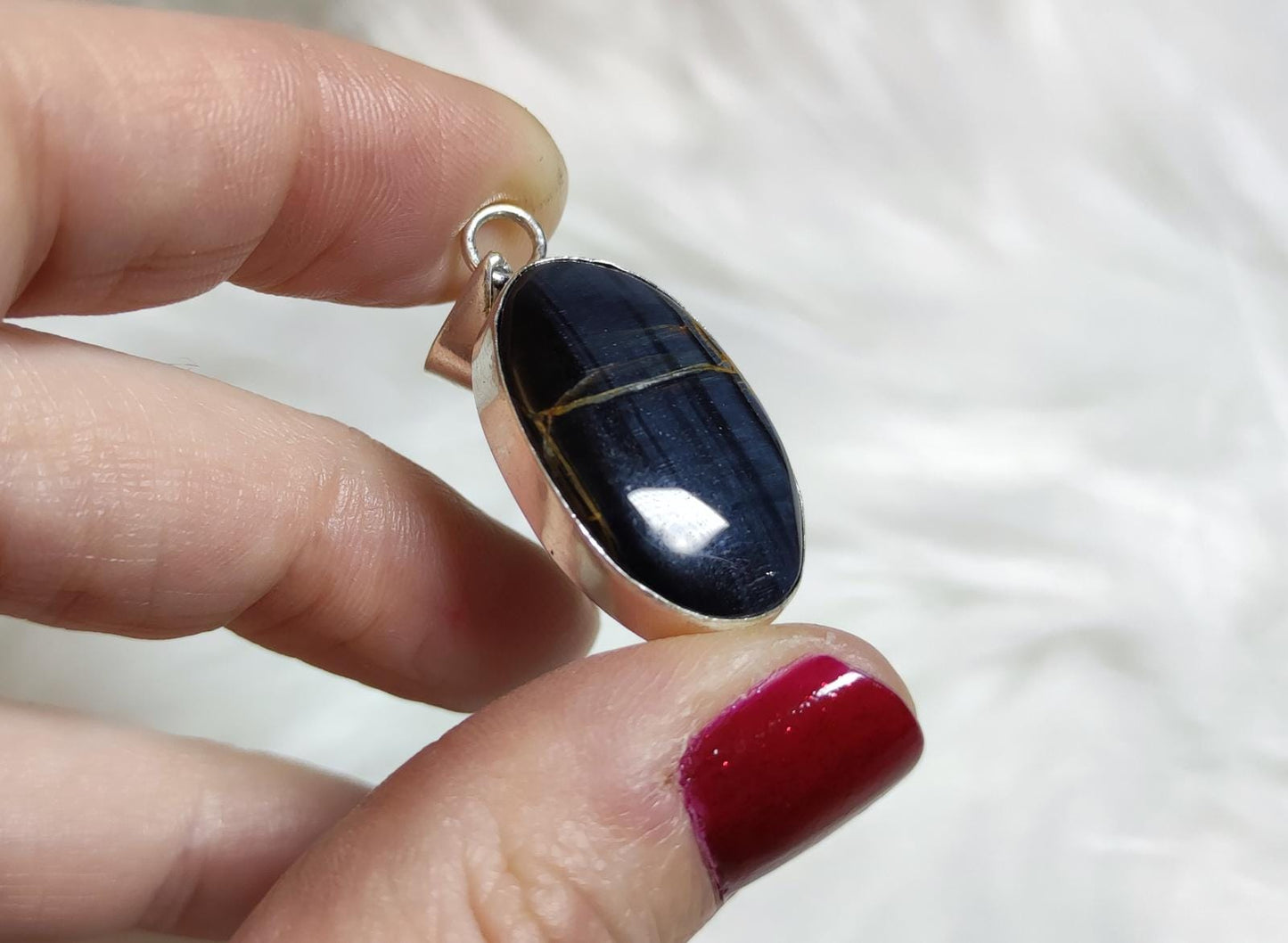 Colgante baño de plata con ojo de halcón